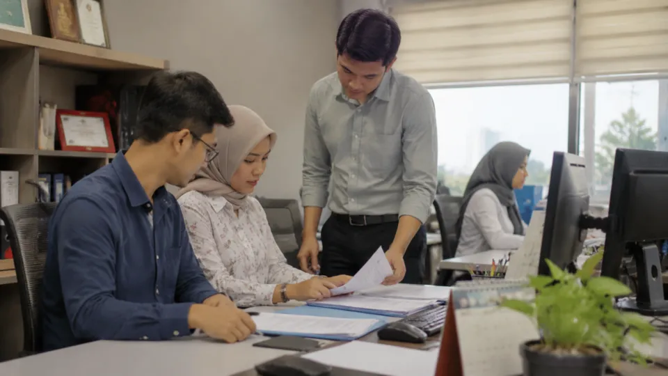 Business team reviewing office documents together